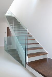 wooden stairs with glass balustrade